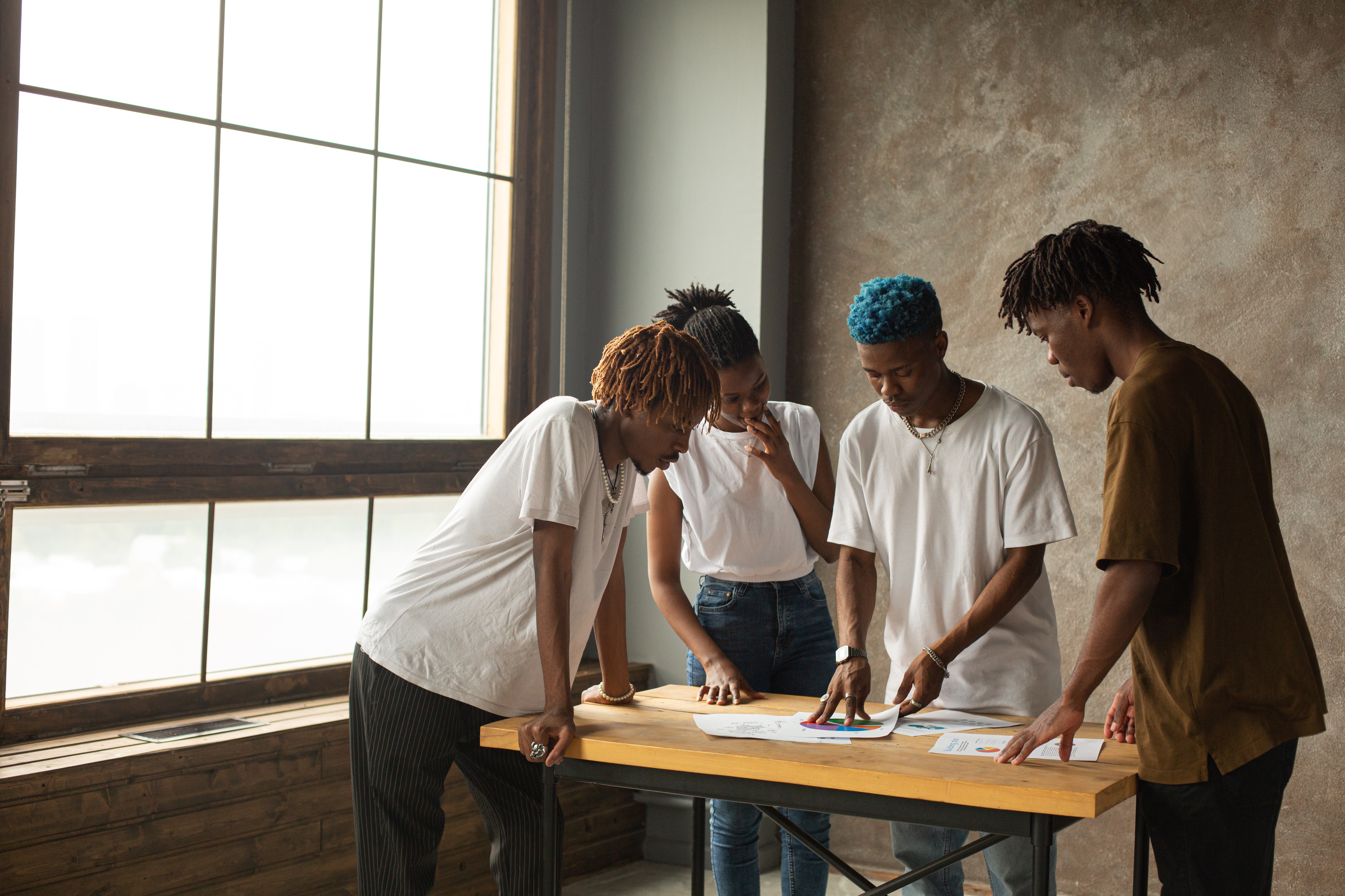 Group of young black people assembling documents on a table